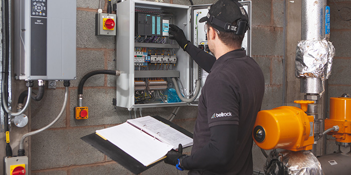 A man working with electrical equipment.